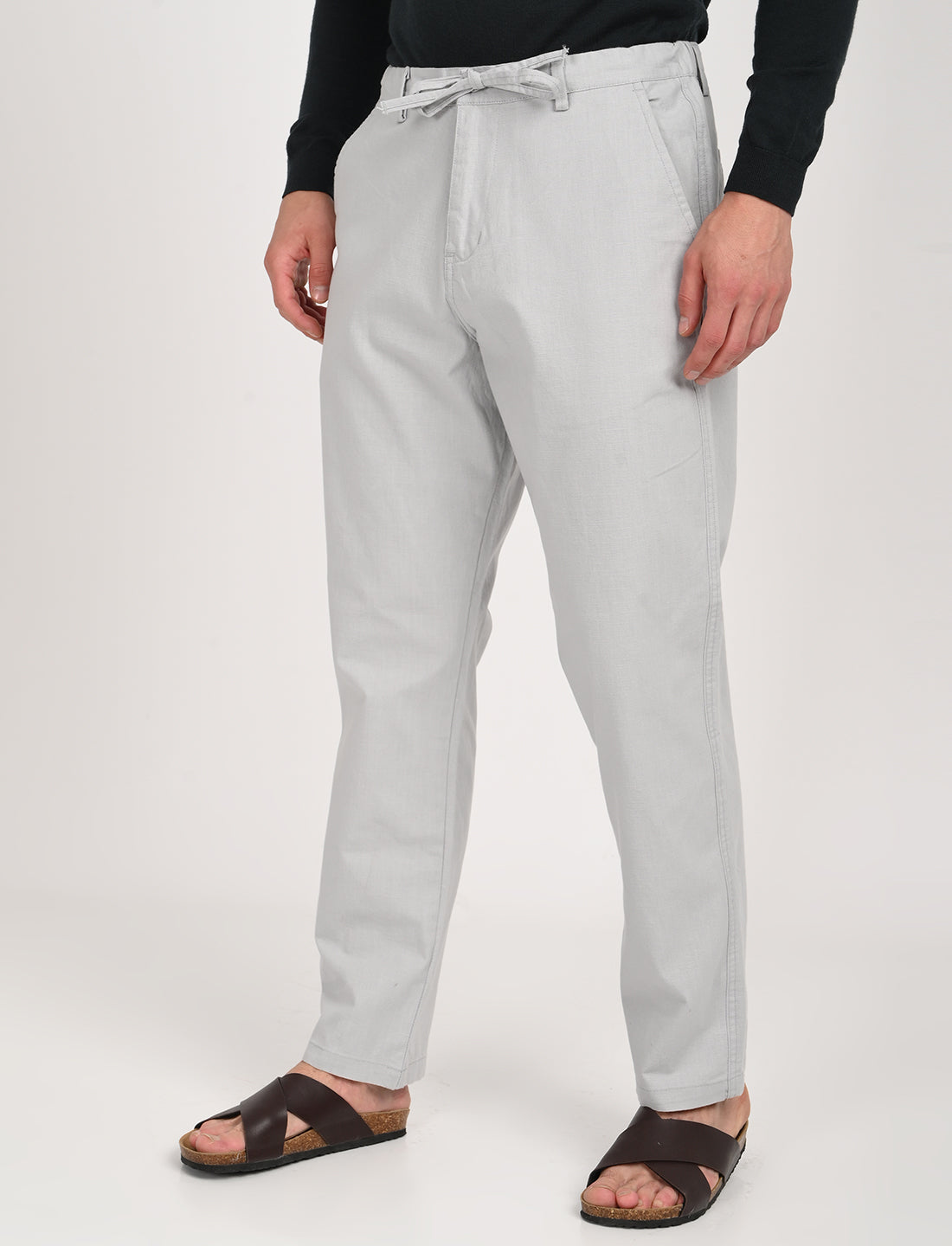 Nova Light Grey Linen Blend Trousers for casual wear, featuring a relaxed fit and paired with stylish sandals.