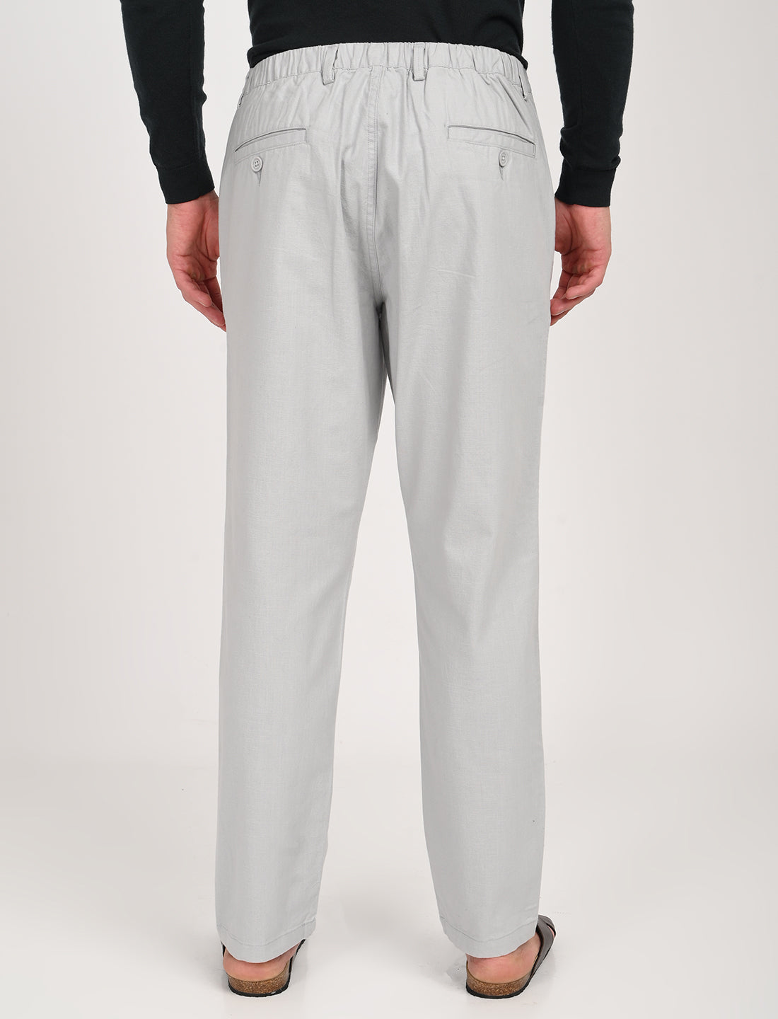Back view of Nova Light Grey Linen Blend Trousers showcasing casual style and elastic waistband for comfort.