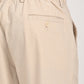 Close-up of the back pocket and waistband of cream linen blend trousers for casual and college wear.