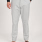 Man wearing Nova light grey linen blend trousers with a casual belt and sandals, ideal for transeasonal casual wear.